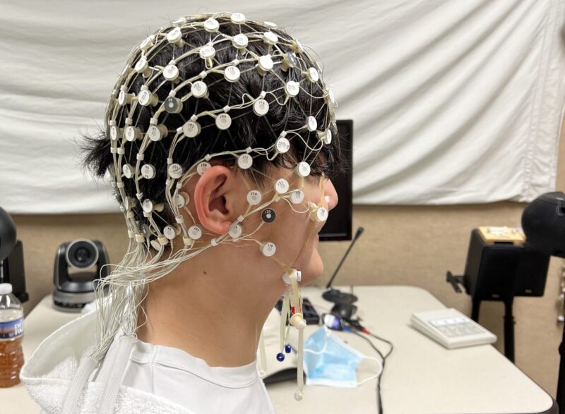 person with wires all over their head/hair