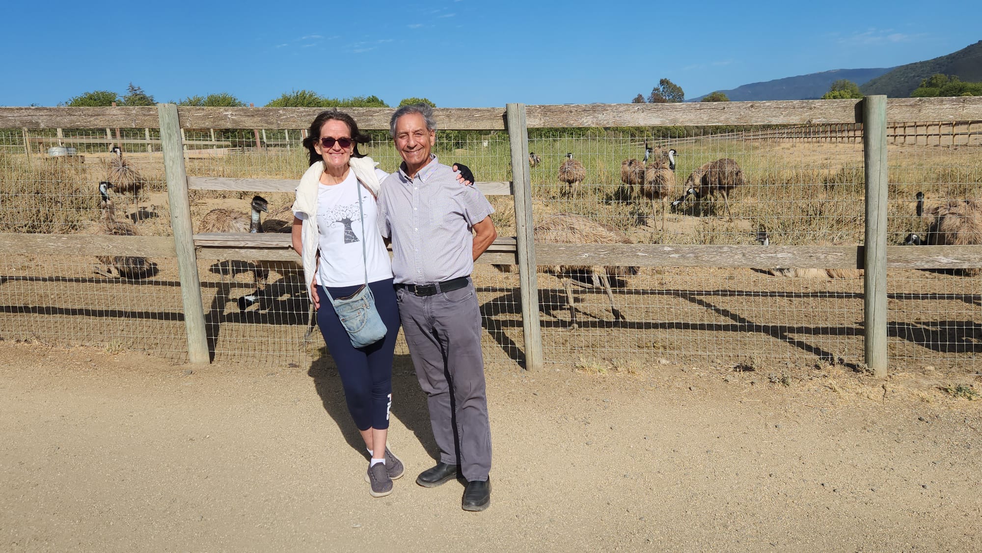 Man and woman in front of a gate in Africa