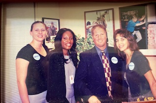 4 people with name tags standing together