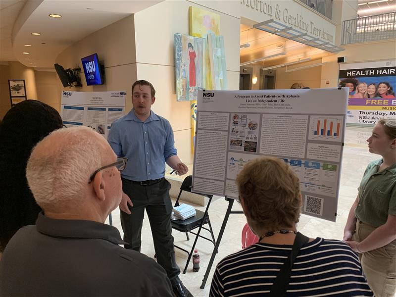 Kesslers listening to a student presentation
